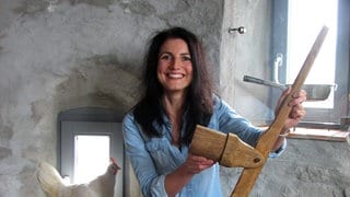 Heidi Huber im Spätzlemuseum. Sie zeigt eine Holzpresse für Spätzle.